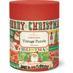 The Vintage Christmas 500 Piece Puzzle by Cavallini Papers and Co comes in a cylindrical container with vintage Christmas graphics like Santa, ornaments, and "Merry Christmas"—perfect for holiday fun.