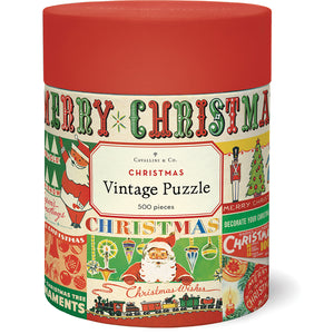 The Vintage Christmas 500 Piece Puzzle by Cavallini Papers and Co comes in a cylindrical container with vintage Christmas graphics like Santa, ornaments, and "Merry Christmas"—perfect for holiday fun.