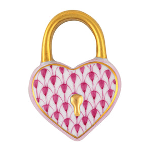The Heart Lock, Raspberry by Herend is a heart-shaped padlock with a gold shackle and keyhole, featuring a white surface adorned with pink petals and gold accents, reflecting the collectible style of handcrafted Herend porcelain.