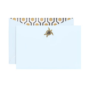 The Crane Sea Turtle Beach Glass Flat Card Set features a light blue envelope with a gold sea turtle seal and black and gold deco lining, offering an elegant introduction.