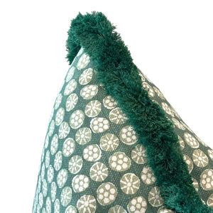 Close-up of the Boheme Green Outdoor Pillow by Associated Design, featuring a white circular pattern and dark green fringed trim, crafted from premium materials.