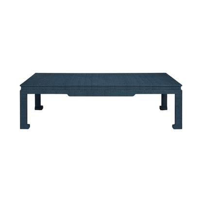 The Wylder Coffee Table by Made Goods is a rectangular blue piece featuring a high gloss linen-textured surface and four straight legs, shown from the front against a white background.