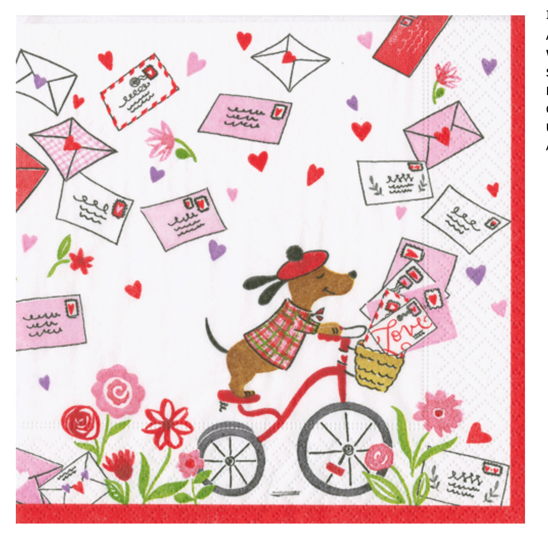 A cartoon dog in a red beret and plaid shirt rides a bike with Caspari's Love Notes Cocktail Napkins and love letters in the basket, surrounded by hearts, flowers, and floating envelopes.