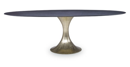 The Julian Chichester Dakota Dining Table features an oblong black stained oak surface, gracefully perched on a sleek, metallic Dante brass flared pedestal base.