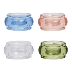 The Provence Napkin Ring Collection by Juliska features four rounded, bubbly glassware napkin rings in blue, pink, clear, and green, displayed against a white background.