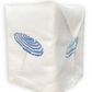 The Haute Home Beach Umbrella Bath Collection features a white Italian linen tissue box cover adorned with embroidered blue and white striped beach umbrellas on two visible sides.