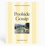 The “Slim Aarons Puzzle Collection” by Piecework is a 1000-piece jigsaw puzzle featuring a photo of people sitting by a pool with mountains and a modern house in the background, printed on high-quality art paper for vibrant colors and durability.