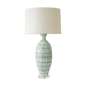 The Elizabeth Lamp in Celadon Drip by Paul Schneider Ceramics features a large beige drum shade and a green ceramic base with an elegant marbled drip banded design.