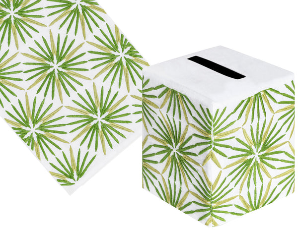 The Haute Home Radiant Bath Collection, Green, includes a hand-embroidered white tissue box cover and table runner crafted from Italian linen with a vibrant green palm leaf pattern.