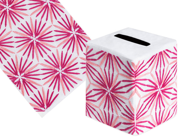 The Haute Home Radiant Bath Collection in pink includes a decorative tissue box cover made from Italian linen, showcasing a hand-embroidered starburst pattern in pink and red on a white background, displayed from two angles.