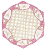 The Fish Meeting Raffia Placemat by Mercedes Salazar features a beige center with a pink and white geometric border with circular and fan patterns, perfect as an exclusive handcrafted accent for your table setting.
