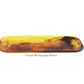 A rectangular amber-hued platter with abstract brown swirls from the Tortoise Resin Serveware Collection by Nashi Home—ideal for stylish home decor.