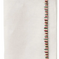 The Kim Seybert Filament Napkin Set features a folded white linen napkin with exquisite red, green, and black embroidered stitching along the edge.