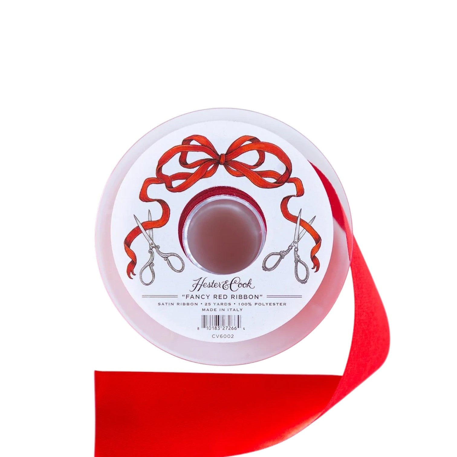 A spool of Fancy Ribbon by Hester & Cook features a decorative label with red bows and silver scissors; ideal for gift wrapping, the satin ribbon is partially unspooled on a white background.