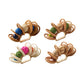 Four Calypso Napkin Rings by Kim Seybert, featuring woven rattan, hand-dyed wooden beads, and colorful yarn balls, artfully arranged on a white background.