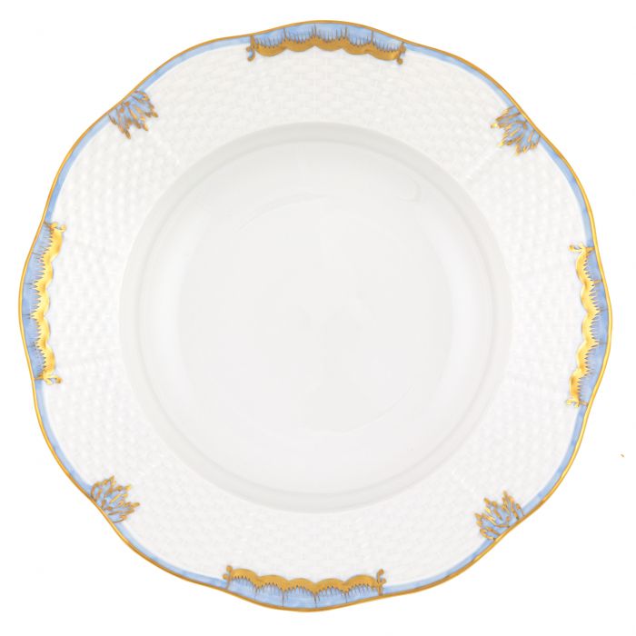 The Herend Princess Victoria Light Blue Collection features a white porcelain plate with a textured rim, hand painted in light blue, gold, and white accents, inspired by the timeless Queen Victoria collection.