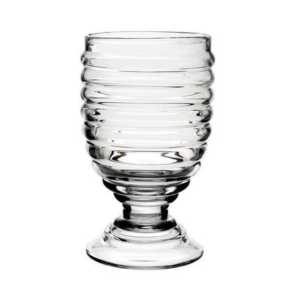 The Ripples Footed Hurricane by William Yeoward Crystal features clear glass with horizontal ripples, a wide round base, and a slightly flared rim, shown against a white background.