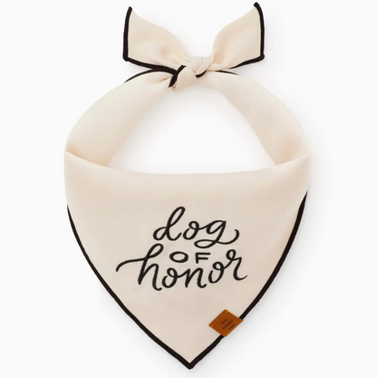 The Foggy Dog’s Dog of Honor Dog Bandana features cream fabric with black trim and “dog of honor” in black script—an adorable accessory for your wedding pup at any special celebration.