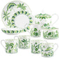 The Cobblers Cove Calypso Dinnerware Collection by Royal Crown Derby features a porcelain tea set with vibrant green botanical patterns, including four mugs, plates, a teapot, creamer, sugar bowl, and a shallow bowl.