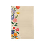 The Rifle Paper Co. Garden Study Collection notepad features beige pages, horizontal lines, and colorful floral illustrations along the left edge—perfect for fans of floral notepads and vibrant desk accessories.