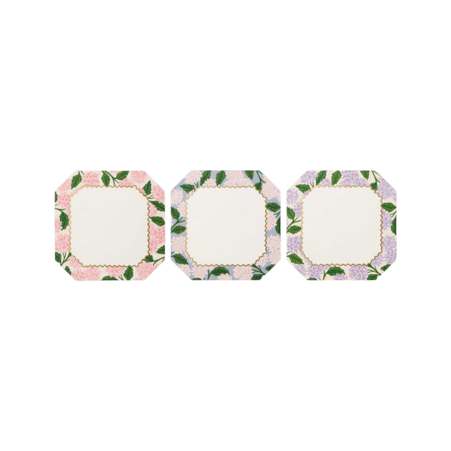 Set of three square scalloped plates, each with a unique pastel floral border—pink, blue, or purple—on white. Inspired by the Pink Hydrangea Collection from Rifle Paper Co., these charming paper goods add elegance to any gathering.