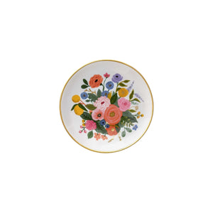A round white plate with a gold rim from Rifle Paper Co.'s Garden Party Collection, featuring a vibrant floral bouquet in the center—perfect for adding charm to your workspace.