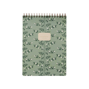 The Climbing Vines Large Top Spiral Notebook by Rifle Paper Co. features a green botanical leaf cover with a central beige label and ruled pages, perfect for keeping your notes organized.