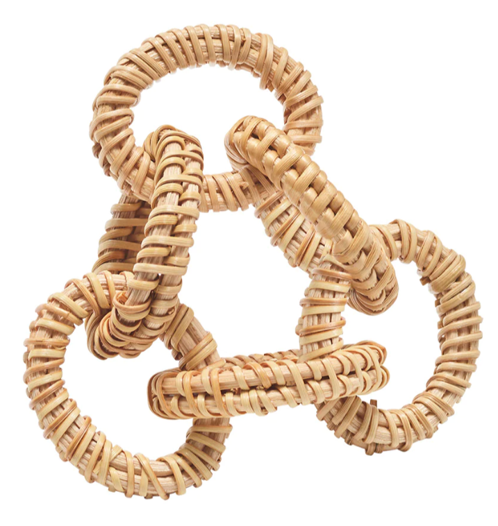 Five interlocking rings of woven light-colored wicker are clustered against a white background, showcasing the coastal charm of Kim Seybert’s Rattan Link Natural Napkin Ring—a perfect summer addition to any table setting.
