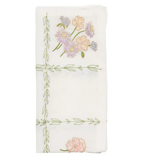 The Kim Seybert Trellis Napkin Set features folded white napkins embroidered with pink and purple flowers and green vines—perfect spring table accents or charming Easter napkins.