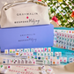 Bespoke x Gray Malin Mahjong Collection featuring patterned tiles, a light purple storage box, and a branded canvas carrying case.