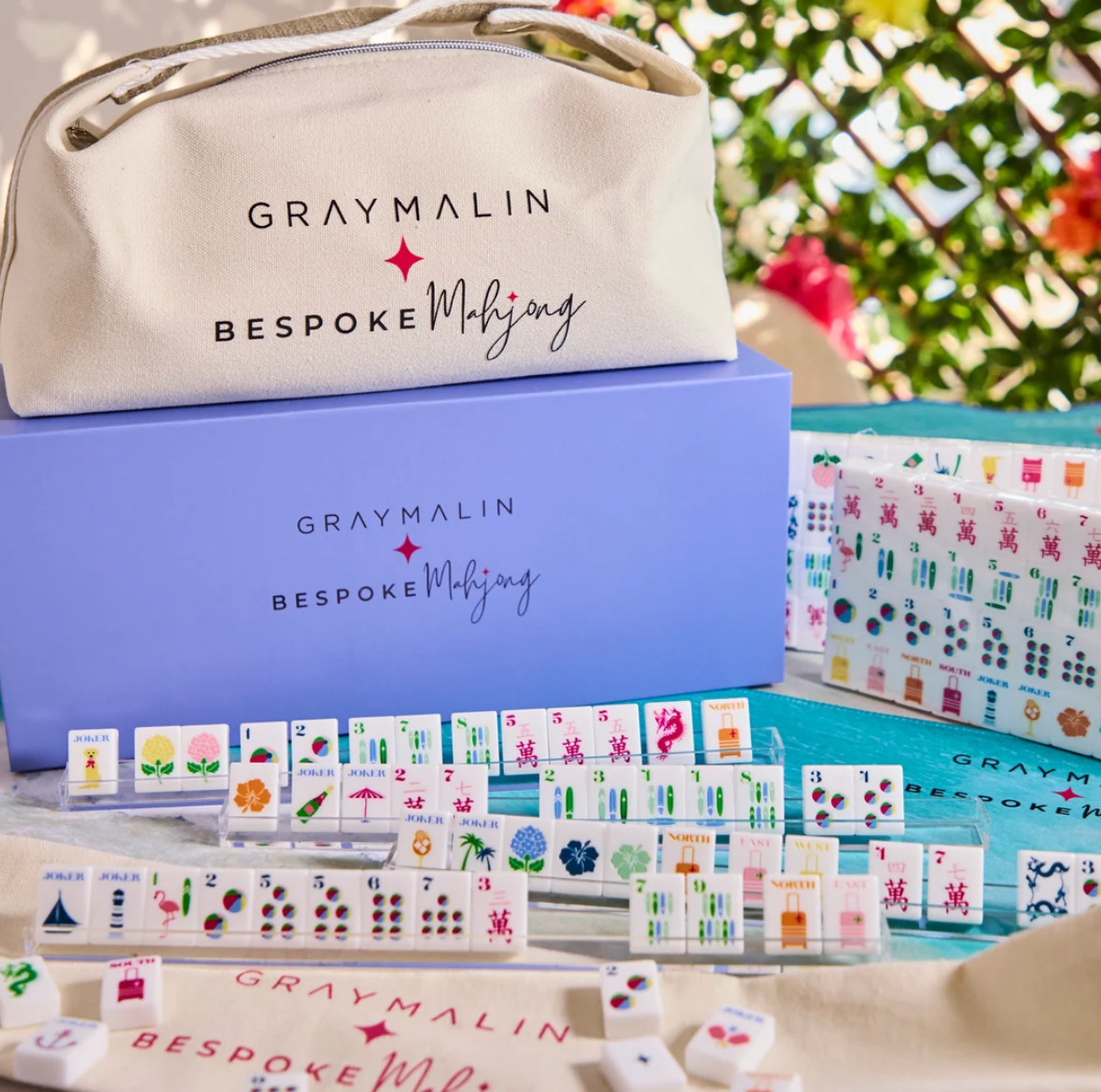 Bespoke x Gray Malin Mahjong Collection featuring patterned tiles, a light purple storage box, and a branded canvas carrying case.