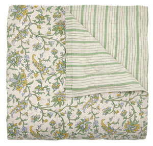 The Tiya Periwinkle King Quilt by John Robshaw is hand quilted from 100% cotton, with a floral pattern in green, yellow, and blue on one side and green and white stripes on the other. (Final Sale).