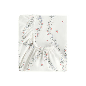 The Gooselings Botanical Berries Bedding Collection features a folded white fitted sheet with a small floral and berry pattern in pink, green, and blue—ideal for pairing with kids' bedding to inspire sweet bedtime dreams.