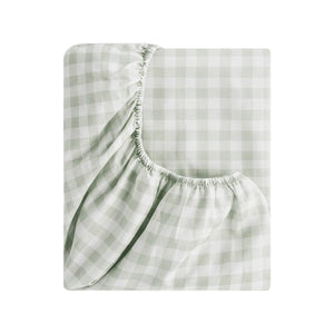 A fitted sheet from the Green Picnic Gingham Bedding Collection by Gooselings, featuring a light green and white check pattern with gathered elastic corners—perfect for children’s bedding.