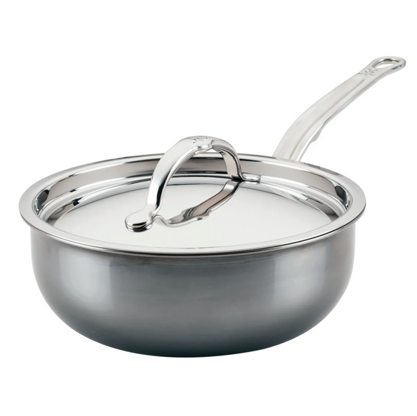 The Hestan NanoBond Titanium Stainless Steel Saucier Pan, 2qt, with a lid and long handle, sits against a white backdrop, highlighting its high heat tolerance and metal utensil safe design.