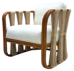 The Strings Attached Lounge Chair from PALECEK's Wits End collection features a natural rattan frame, white upholstered seat and backrest, and natural fiber rope accents on the sides and back.