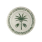 From the Casa Dark Jungle Dinnerware Collection by Johanna Ortiz, this white ceramic plate showcases a hand-painted green palm tree with two monkeys and a leafy border, inspired by Carmen de Viboral’s artisanal heritage.
