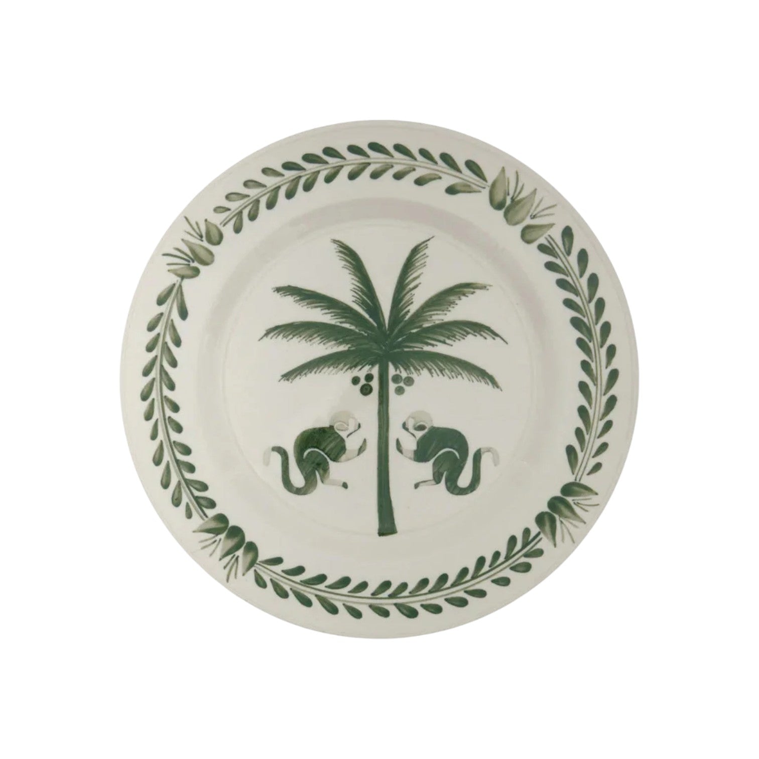 From the Casa Dark Jungle Dinnerware Collection by Johanna Ortiz, this white ceramic plate showcases a hand-painted green palm tree with two monkeys and a leafy border, inspired by Carmen de Viboral’s artisanal heritage.