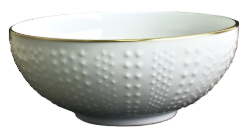 Inspired by French artisans, the Corail Gold Collection by Medard de Noblat/Devine features a white ceramic bowl with a textured dotted exterior and a delicate gold rim.