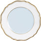 A white porcelain plate from the Mazurka Or Fond Bleu Gris dinnerware collection by Raynaud, featuring scalloped edges and a gold rim, is shown photographed from above on a white background.