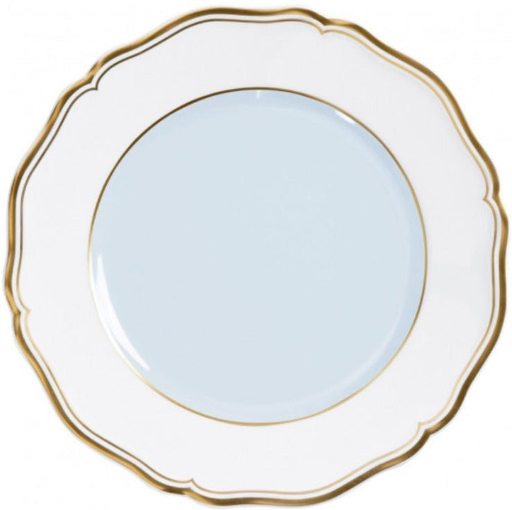 A white porcelain plate from the Mazurka Or Fond Bleu Gris dinnerware collection by Raynaud, featuring scalloped edges and a gold rim, is shown photographed from above on a white background.