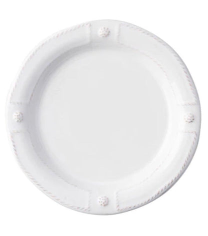 A plain white ceramic plate from Juliska's Berry & Thread French Panel Dinnerware Collection, featuring a slightly raised rim with four decorative knobs, inspired by classic Parisian architecture.