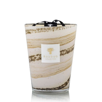 A Baobab Collection Sand Siloli Candle in a decorative glass container with beige and golden swirling patterns, isolated on a white background, enhanced with the scent of cedarwood tonka bean.