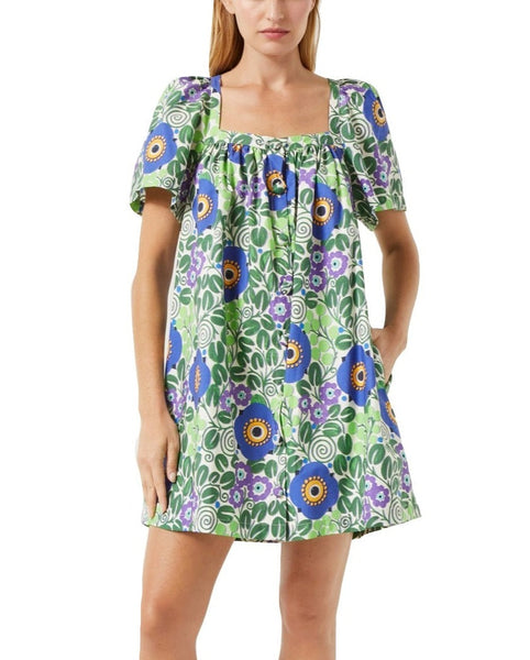 A woman modeling a short Rhode Sarina dress with puffed sleeves and a round neckline, featuring an Aura Blossom print in a green, blue, and purple color scheme.