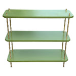 The Satin Lacquered Console Table by Two Worlds Arts Group features green shelves and brass bamboo legs, making it a stylish addition that brings elegance to any minimalist table setting.