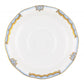 The Herend Princess Victoria Light Blue Collection saucer, crafted by Herend, invites artistic appreciation with its delicate hand-painted designs. This white porcelain saucer features a scalloped edge adorned with gold and light blue accents.