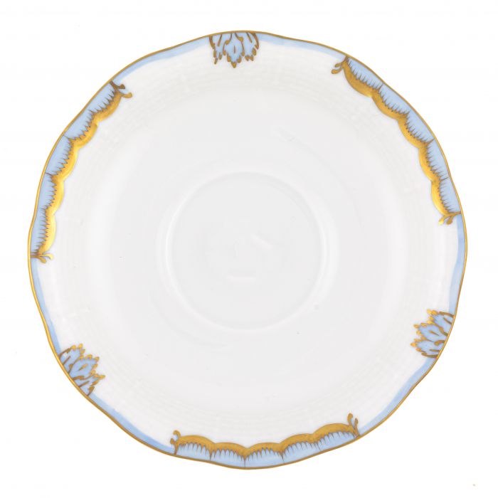 The Herend Princess Victoria Light Blue Collection saucer, crafted by Herend, invites artistic appreciation with its delicate hand-painted designs. This white porcelain saucer features a scalloped edge adorned with gold and light blue accents.