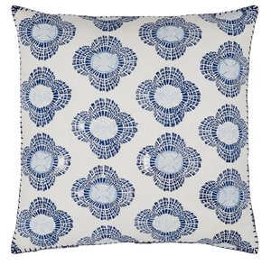 The Nikita Pillow by John Robshaw is a square white accent featuring blue and navy stylized blossoms in a mosaic pattern, with indigo lines evenly spaced across the surface.