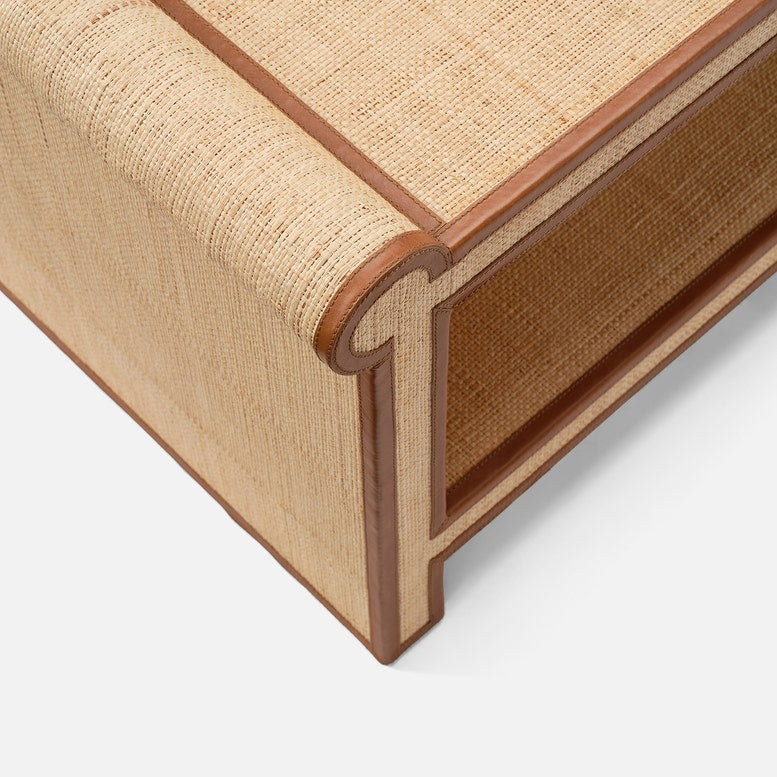 Close-up of the Made Goods Matthew Coffee Table, a rectangular design with rounded edges, showcasing its detailed woven raffia texture and smooth full-grain leather trim for a unique shape and premium finish.