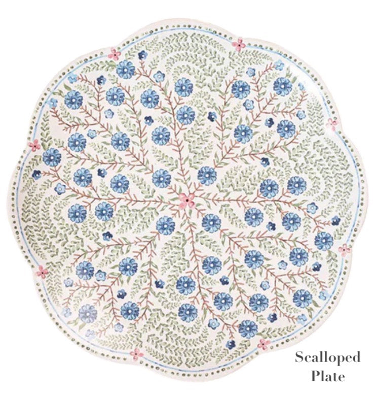 The Juliska Villa Seville Chambray Dinnerware Collection features a round scalloped plate with blue florals and green leaves on white, ideal for adding classic floral charm to your table.